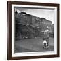 Young Boy and His Dog Standing at the Crossing as a Train Rides Through-Myron Davis-Framed Photographic Print