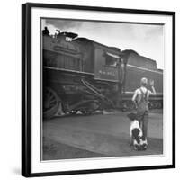 Young Boy and His Dog Standing at the Crossing as a Train Rides Through-Myron Davis-Framed Photographic Print