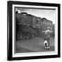 Young Boy and His Dog Standing at the Crossing as a Train Rides Through-Myron Davis-Framed Photographic Print