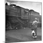 Young Boy and His Dog Standing at the Crossing as a Train Rides Through-Myron Davis-Mounted Photographic Print