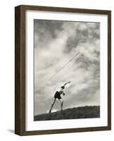 Young Boy Atop a Hill Hurls a Javelin into the Air-null-Framed Photographic Print