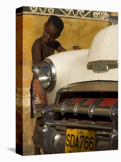 Young Boy Drumming on Old American Car's Bonnet,Trinidad, Sancti Spiritus Province, Cuba-Eitan Simanor-Stretched Canvas