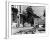 Young boy looking in shop window in the Cotswolds, 1935-Bernard Alfieri-Framed Photographic Print