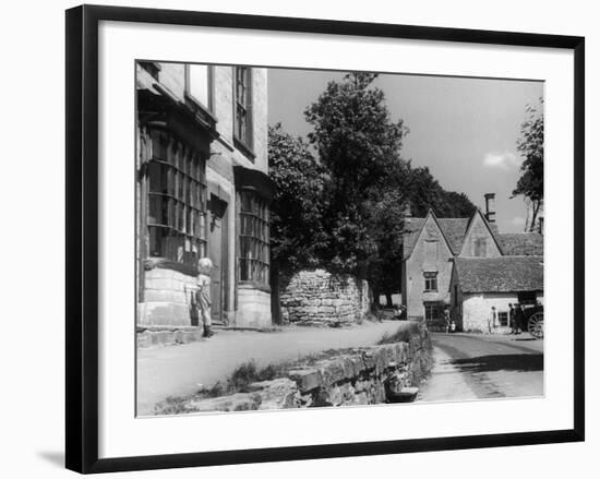 Young boy looking in shop window in the Cotswolds, 1935-Bernard Alfieri-Framed Photographic Print