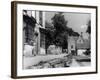 Young boy looking in shop window in the Cotswolds, 1935-Bernard Alfieri-Framed Photographic Print