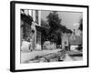 Young boy looking in shop window in the Cotswolds, 1935-Bernard Alfieri-Framed Photographic Print