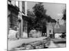 Young boy looking in shop window in the Cotswolds, 1935-Bernard Alfieri-Mounted Photographic Print