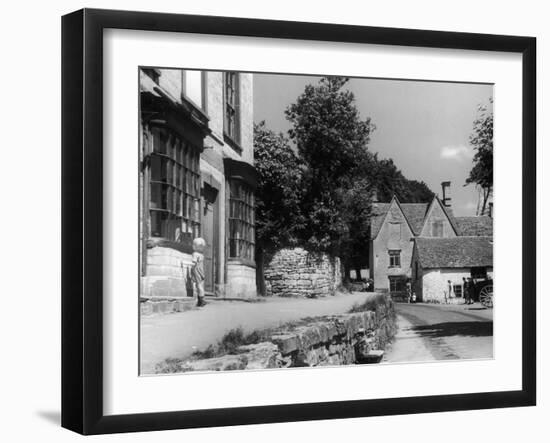 Young boy looking in shop window in the Cotswolds, 1935-Bernard Alfieri-Framed Photographic Print