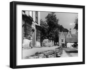 Young boy looking in shop window in the Cotswolds, 1935-Bernard Alfieri-Framed Photographic Print