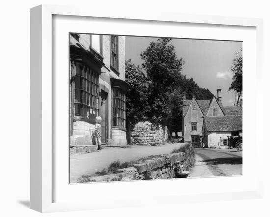 Young boy looking in shop window in the Cotswolds, 1935-Bernard Alfieri-Framed Photographic Print