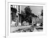 Young boy looking in shop window in the Cotswolds, 1935-Bernard Alfieri-Framed Photographic Print