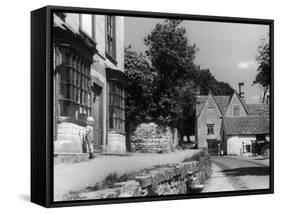 Young boy looking in shop window in the Cotswolds, 1935-Bernard Alfieri-Framed Stretched Canvas