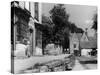 Young boy looking in shop window in the Cotswolds, 1935-Bernard Alfieri-Stretched Canvas