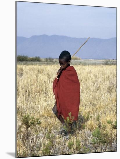 Young Boy of the Datoga Tribe Crosses the Plains East of Lake Manyara in Northern Tanzania-Nigel Pavitt-Mounted Photographic Print