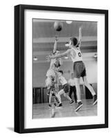 Young Boy Shooting a Free-Throw Shot over the Head of Another Young Boy-null-Framed Photographic Print