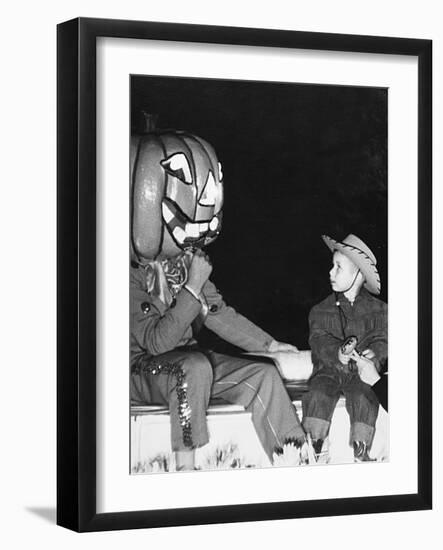 Young Boy Warily Eyes Pumpkin Man, Ca. 1955-null-Framed Photographic Print