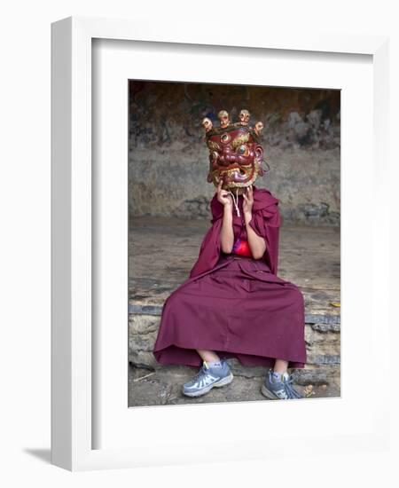 Young Buddhist Monk Holding Traditional Carved Wooden Mask to His Face at the Tamshing Phala Choepa-Lee Frost-Framed Photographic Print