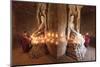 Young Buddhist monks pray in front of a statue of Buddha in a temple in Bagan, Myanmar-Tim Mannakee-Mounted Photographic Print