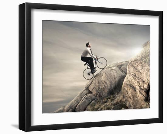 Young Businessman Pedaling a Bicycle on the Rocks-olly2-Framed Photographic Print