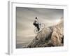 Young Businessman Pedaling a Bicycle on the Rocks-olly2-Framed Photographic Print