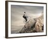 Young Businessman Pedaling a Bicycle on the Rocks-olly2-Framed Photographic Print