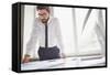 Young Businessman Standing by the Window in Office and Working with Papers-pressmaster-Framed Stretched Canvas
