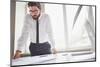 Young Businessman Standing by the Window in Office and Working with Papers-pressmaster-Mounted Photographic Print