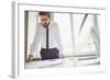 Young Businessman Standing by the Window in Office and Working with Papers-pressmaster-Framed Photographic Print