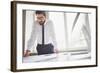 Young Businessman Standing by the Window in Office and Working with Papers-pressmaster-Framed Photographic Print