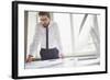 Young Businessman Standing by the Window in Office and Working with Papers-pressmaster-Framed Photographic Print