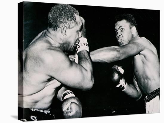 Young Cassius Clay Scores with a Left Against the Veteran Archie Moore in the First Round of the?-American Photographer-Stretched Canvas