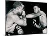 Young Cassius Clay Scores with a Left Against the Veteran Archie Moore in the First Round of the?-American Photographer-Mounted Premium Photographic Print