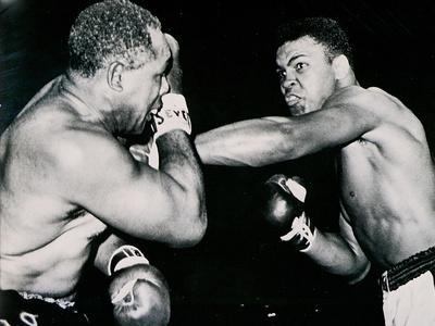 https://imgc.allpostersimages.com/img/posters/young-cassius-clay-scores-with-a-left-against-the-veteran-archie-moore-in-the-first-round-of-the_u-L-PJLAWY0.jpg?artPerspective=n