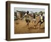 Young Children Play Soccer on a Dirt Pitch by the Side of Railway Tracks-null-Framed Photographic Print