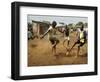 Young Children Play Soccer on a Dirt Pitch by the Side of Railway Tracks-null-Framed Photographic Print