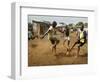 Young Children Play Soccer on a Dirt Pitch by the Side of Railway Tracks-null-Framed Photographic Print