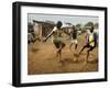 Young Children Play Soccer on a Dirt Pitch by the Side of Railway Tracks-null-Framed Photographic Print