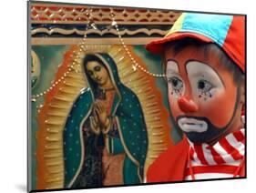 Young Clown, "Bolillito," Stands Next to an Image of the Virgin of Guadalupe in Mexico City-null-Mounted Photographic Print