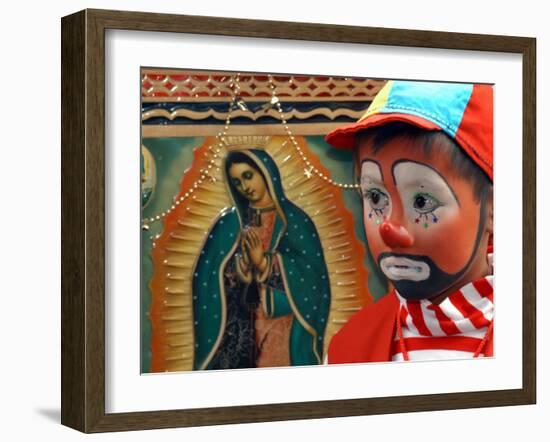 Young Clown, "Bolillito," Stands Next to an Image of the Virgin of Guadalupe in Mexico City-null-Framed Photographic Print