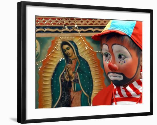 Young Clown, "Bolillito," Stands Next to an Image of the Virgin of Guadalupe in Mexico City-null-Framed Photographic Print