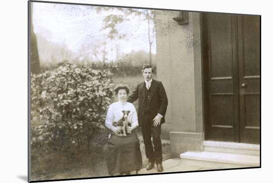 Young Couple and a Puppy in a Garden-null-Mounted Photographic Print