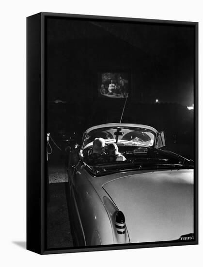 Young Couple Cuddling as They Watch a Movie at Drive in Theater-Francis Miller-Framed Stretched Canvas