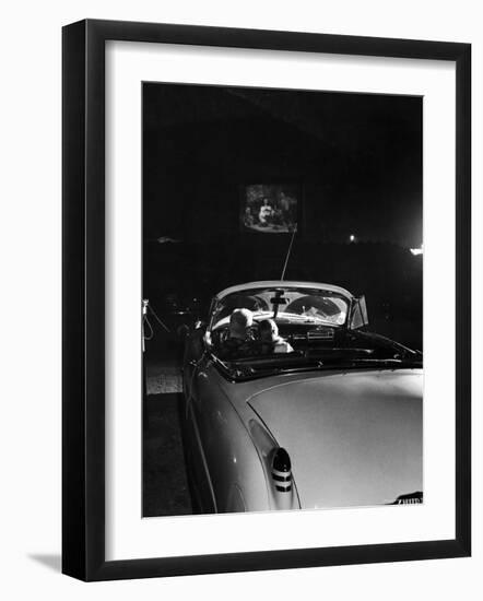 Young Couple Cuddling as They Watch a Movie at Drive in Theater-Francis Miller-Framed Premium Photographic Print