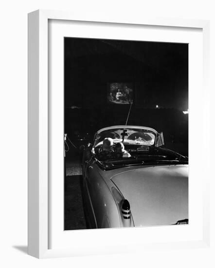 Young Couple Cuddling as They Watch a Movie at Drive in Theater-Francis Miller-Framed Photographic Print