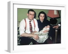 Young Couple Holding Baby Boy in Christening Gown, Ca. 1952-null-Framed Premium Photographic Print