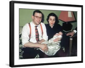 Young Couple Holding Baby Boy in Christening Gown, Ca. 1952-null-Framed Photographic Print