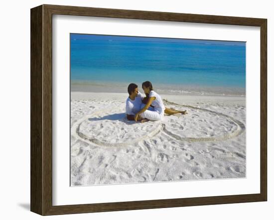 Young Couple on Beach Sitting in a Heart Shaped Imprint on the Sand, Maldives, Indian Ocean, Asia-Sakis Papadopoulos-Framed Photographic Print