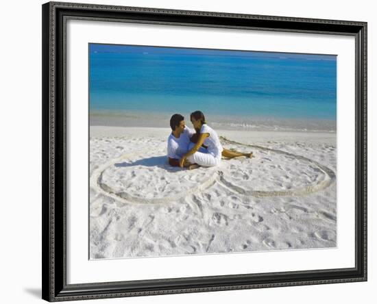 Young Couple on Beach Sitting in a Heart Shaped Imprint on the Sand, Maldives, Indian Ocean, Asia-Sakis Papadopoulos-Framed Photographic Print