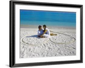 Young Couple on Beach Sitting in a Heart Shaped Imprint on the Sand, Maldives, Indian Ocean, Asia-Sakis Papadopoulos-Framed Photographic Print