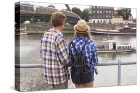 Young Couple on the River Bank in a European City (Rear View) Romantic Journey.-De Visu-Stretched Canvas